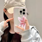 Person holding a phone with a floral case against a neutral background