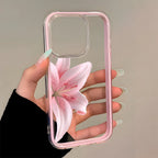 Phone case with pink flower design held by a hand against a neutral background