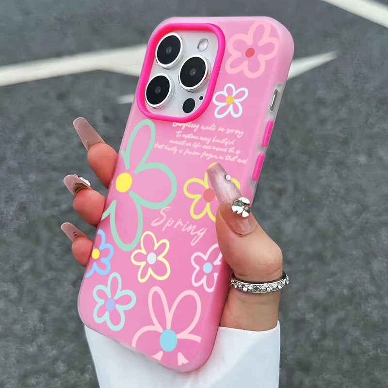 Pink floral phone case held by a hand with a blurred background