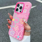 Pink floral phone case held by a hand with a blurred background