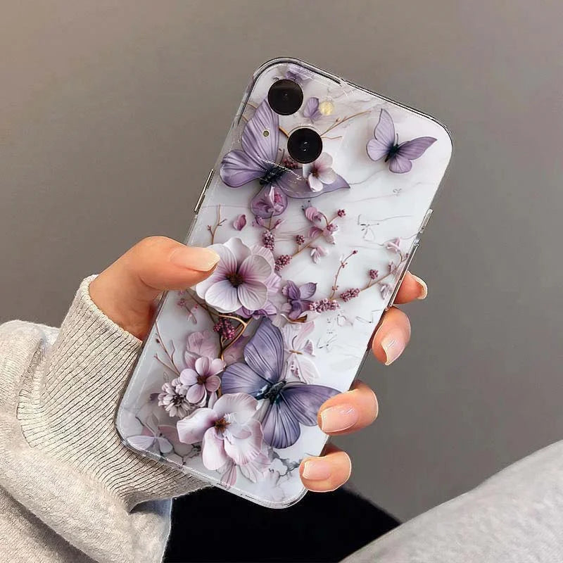 Phone case with floral and butterfly design held by a person