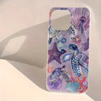 A clear phone case featuring a colorful watercolor design of sea turtles, starfish, jellyfish, and seashells on a light purple background, shown standing on a white surface with a soft shadow.