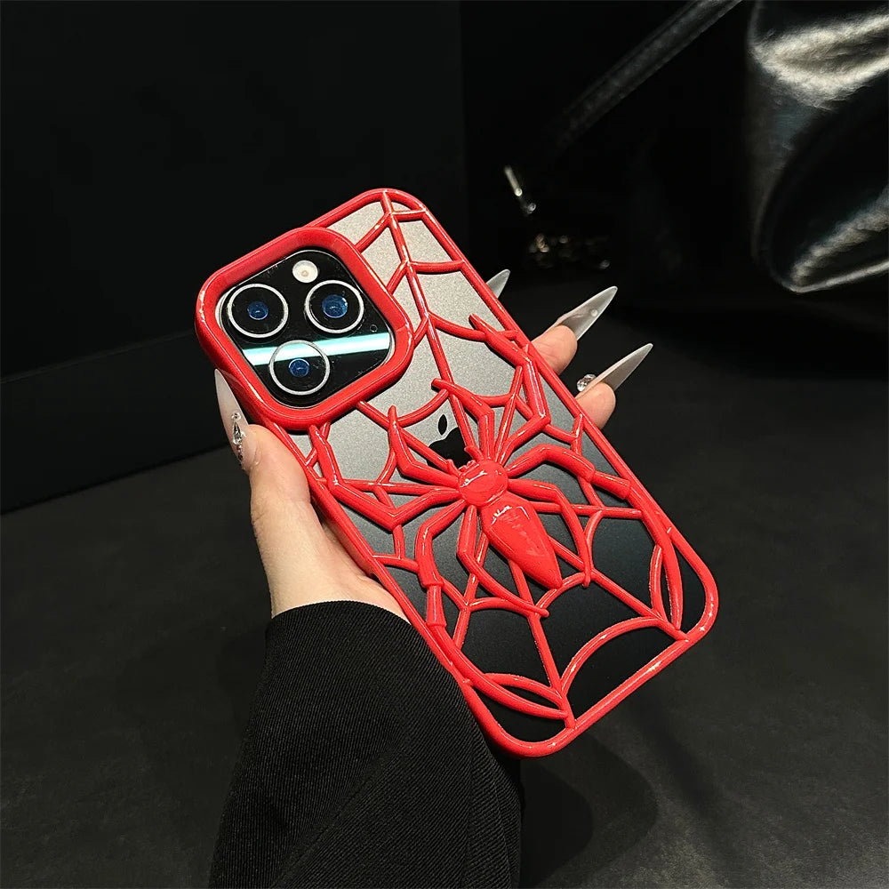 Phone case with spider design held by a hand against a dark background