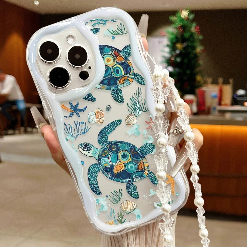 Phone case with turtle design held by a person in a casual setting