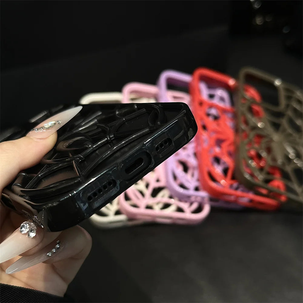 Black phone case held by a hand with blurred colorful cases in the background