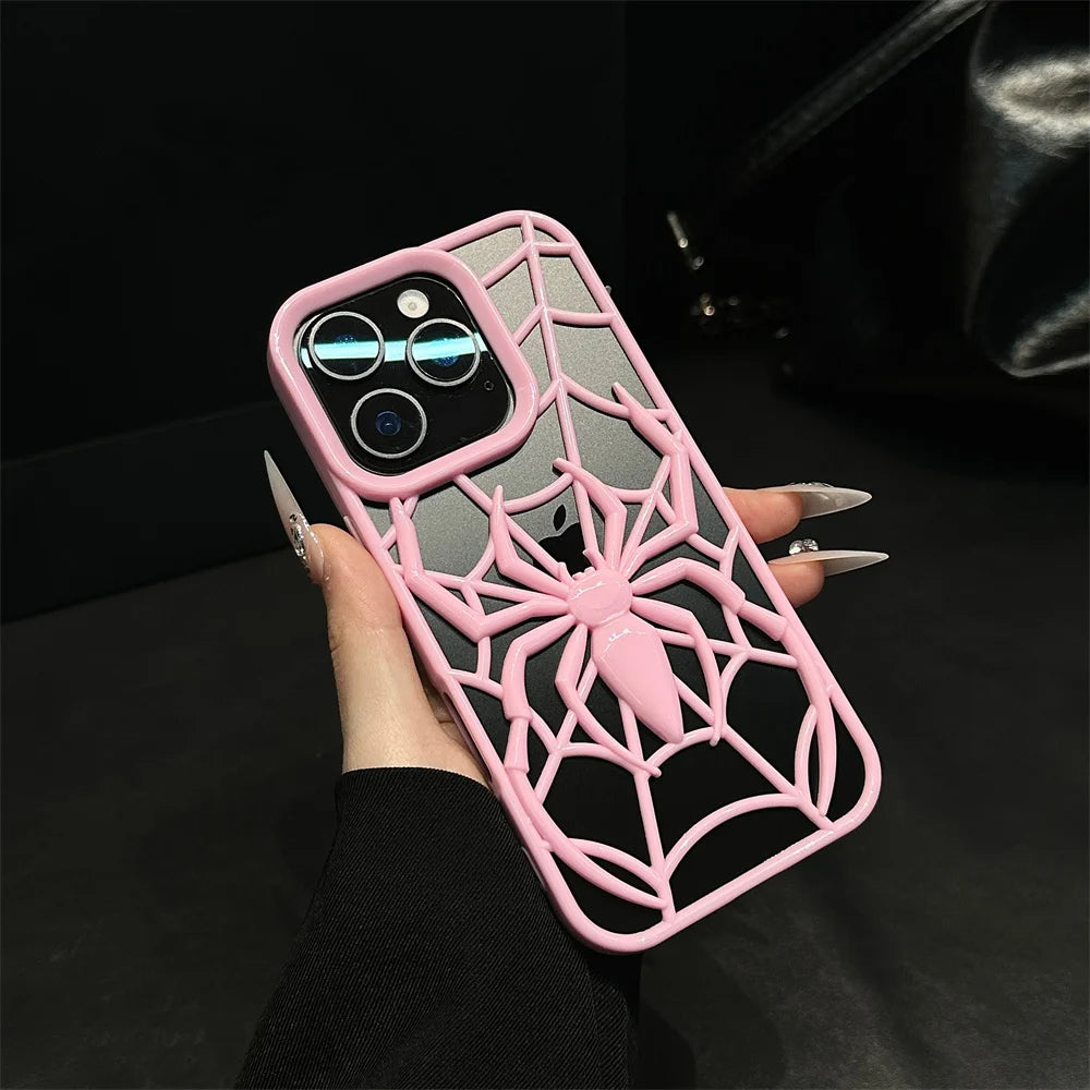 Pink spider web phone case held by a hand on a dark background