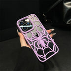 Phone case with spider design held by a hand against a dark background