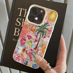 Colorful phone case with tropical design held over a book