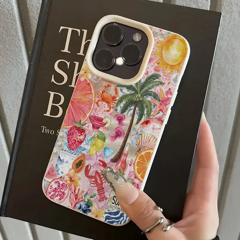 Colorful phone case with tropical design held over a book