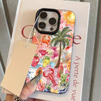 Phone case with tropical design held over a book