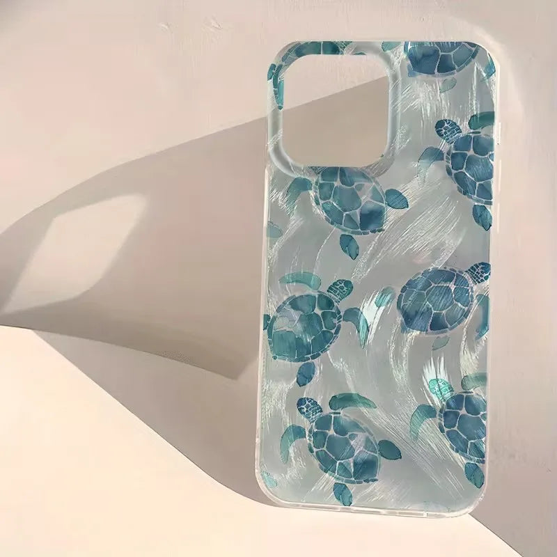 A clear phone case featuring a pattern of blue and teal sea turtles, shown on a light beige background with a soft shadow.