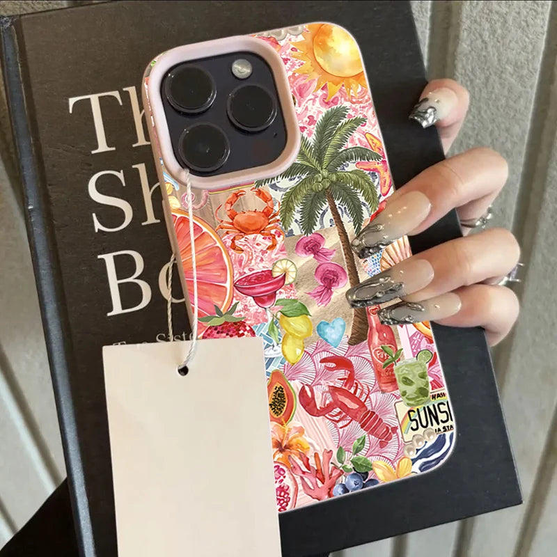 Phone case with tropical design held by a hand on a book