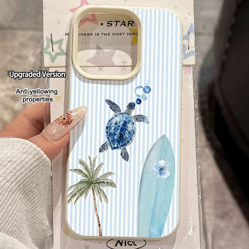 A hand holds a light blue and white striped phone case featuring a blue turtle, a palm tree, and a light blue surfboard. The case has a beige camera cutout and is shown in its retail packaging with promotional text overlays.