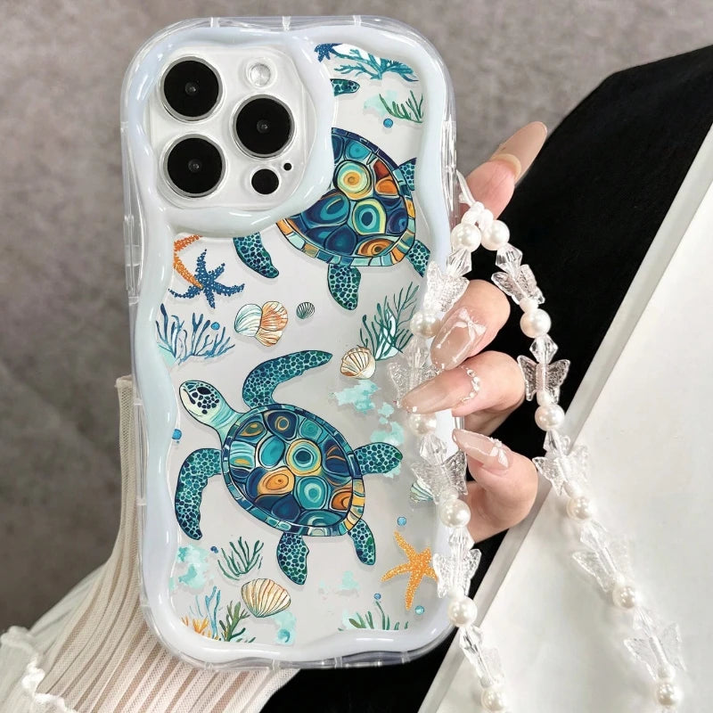 Phone case with turtle design held by a person