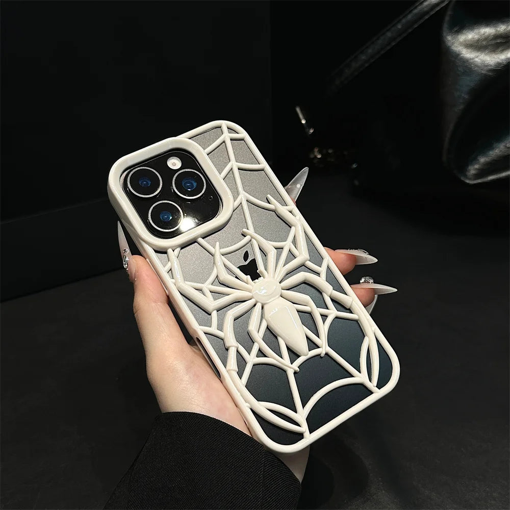 Phone case with spider web design held by a hand against a dark background