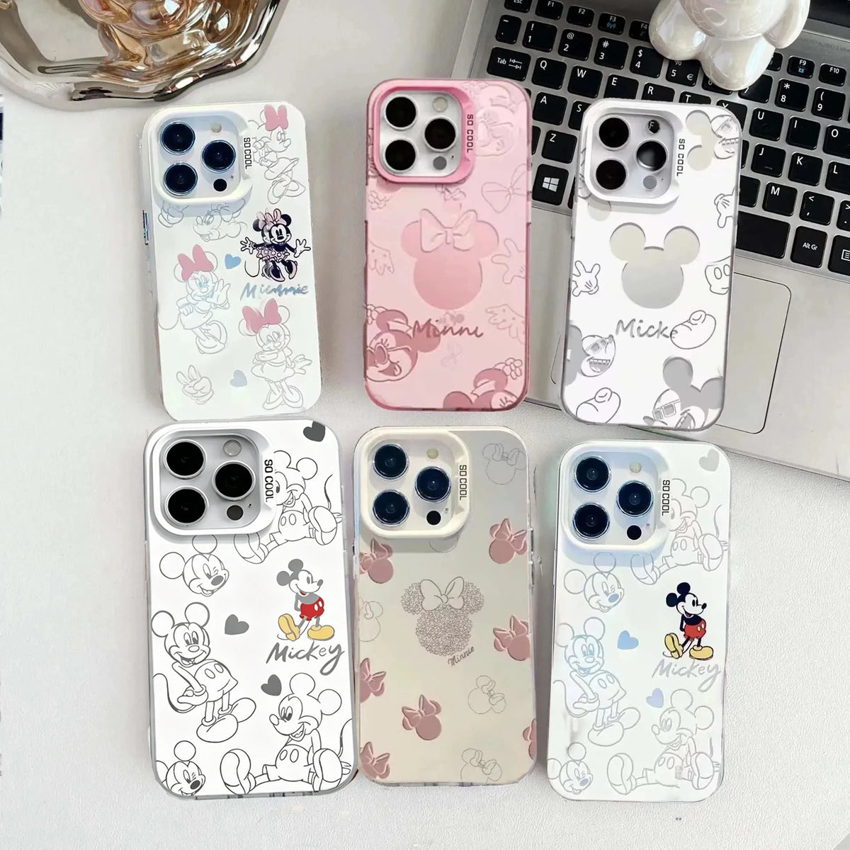 Cute cartoon mouse pattern phone cases in matte pink and white options.