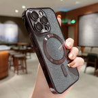 Phone case with glittery finish and ring holder held by a hand in an indoor setting.