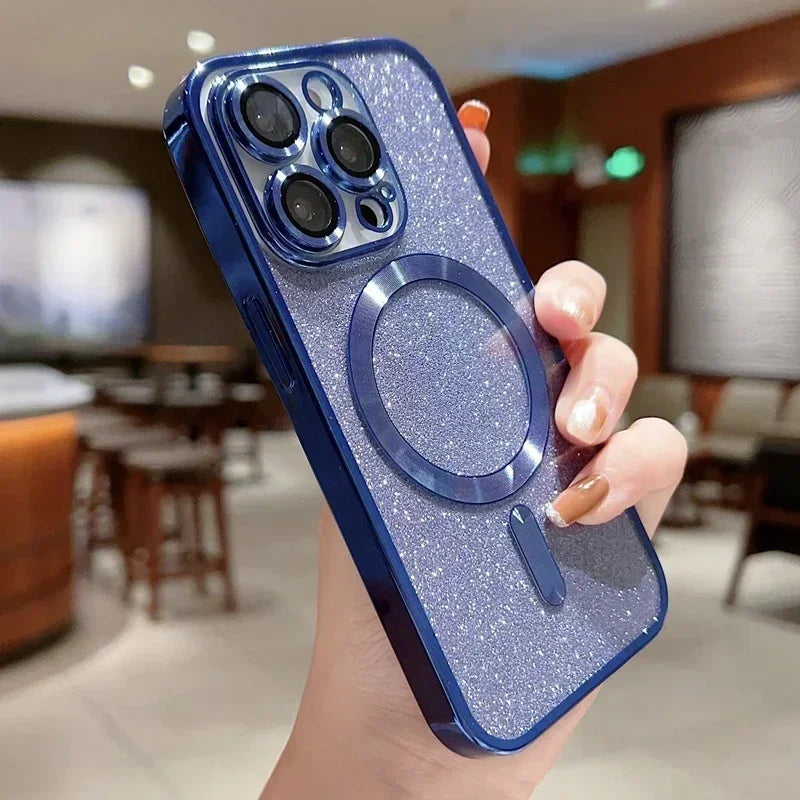 Hand holding a blue glittery phone case with a metallic ring holder in an indoor setting.