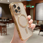Hand holding a glittery phone case with a metallic ring holder in an indoor setting.