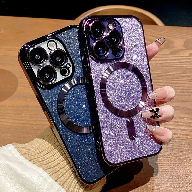 Two glittery phone cases with ring holders on a wooden surface.