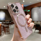 Pink glittery phone case with a ring holder held by a hand in an indoor setting.
