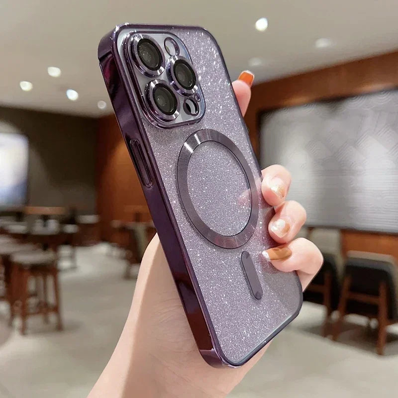 Hand holding a purple glittery phone case with a metallic ring holder in an indoor setting.