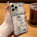 A hand holding a clear phone case featuring black line art of The Lion King characters and the Disney logo, shown over a wooden table next to an iced coffee.