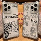 Two clear phone cases held in hands over a wooden surface. One case has black line art of Simba and Nala with 'THE LION KING' text and Disney logo, and the other has multiple Lion King character line drawings.