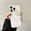 Phone case with a bear design and pink polka dots held by a hand against a neutral background