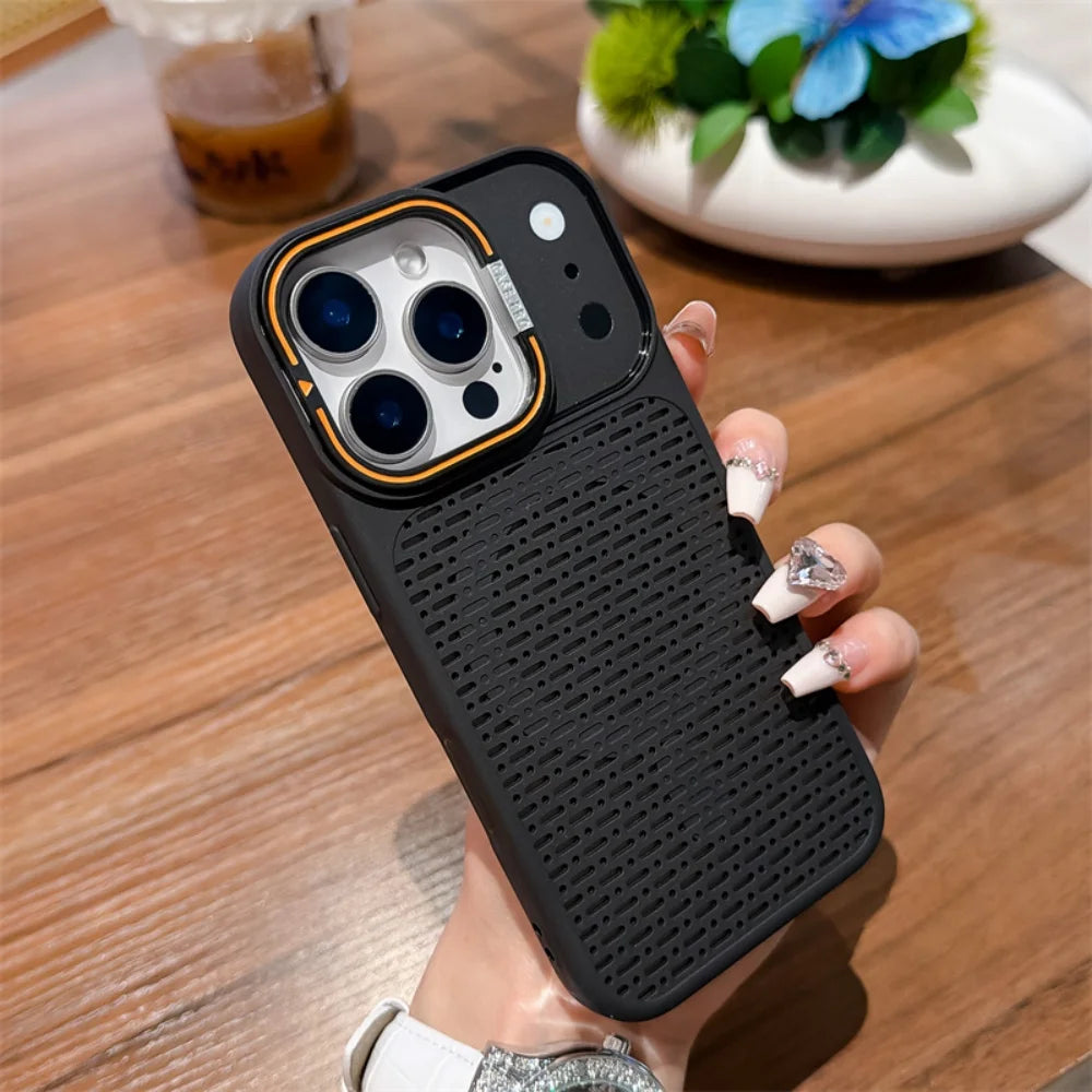 A hand holding a black textured phone case with a gold accent ring around the camera cutout, shown over a wooden table background.