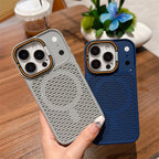 Two textured magnetic phone cases, one light gray and one dark blue, held in a hand over a wooden table background.