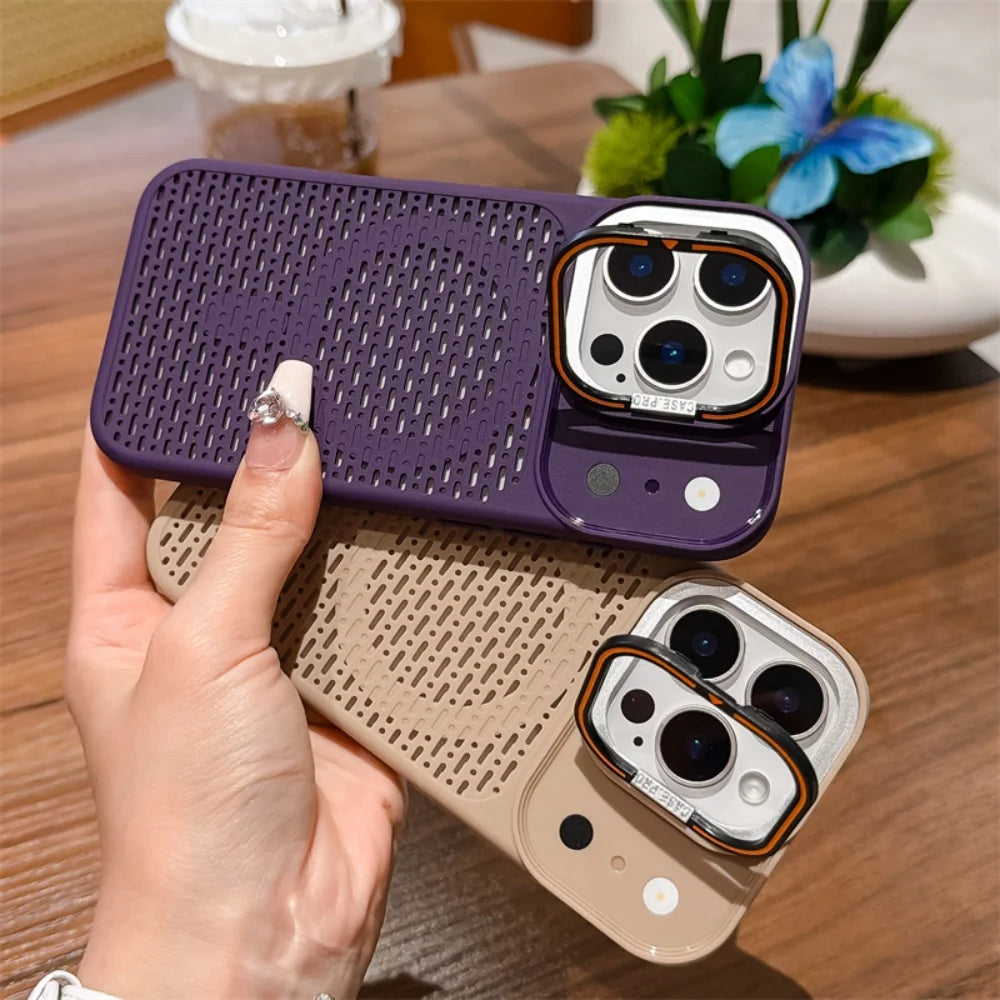 A hand holds two phone cases with a distinctive circular cutout pattern and a raised camera bezel. One case is deep purple and the other is beige, both shown fitted on phones over a wooden table background.