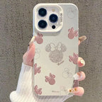 Matte pink cell phone case with large cartoon character face print held in hand.
