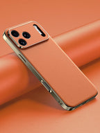 Smartphone with a gold case on an orange background