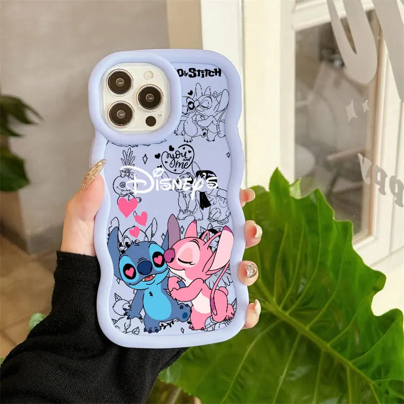 A hand holding a light blue wavy phone case featuring Disney Stitch and Angel hugging, with other Disney characters and text like 'Love Never Dies' and 'Disney' printed on the back.