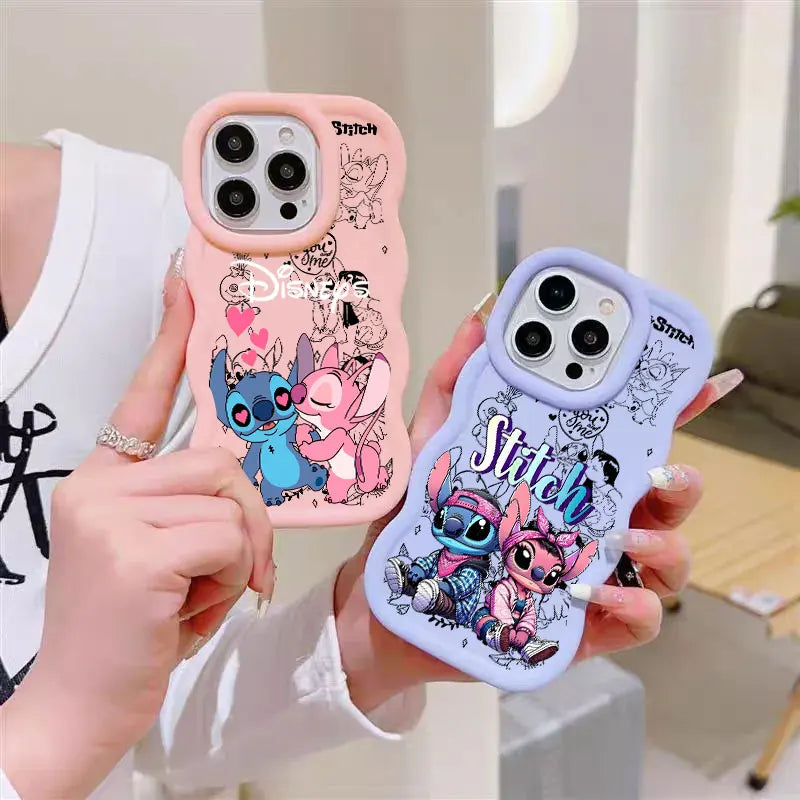 Two phone cases held in hands, one pink and one light purple, both featuring Disney Stitch cartoon graphics and camera cutouts.