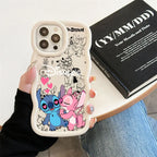 A hand holds a white phone case featuring cartoon characters Stitch and Angel with pink hearts and black doodle graphics. The case is shown on a phone, with a black book and blue jeans in the background.