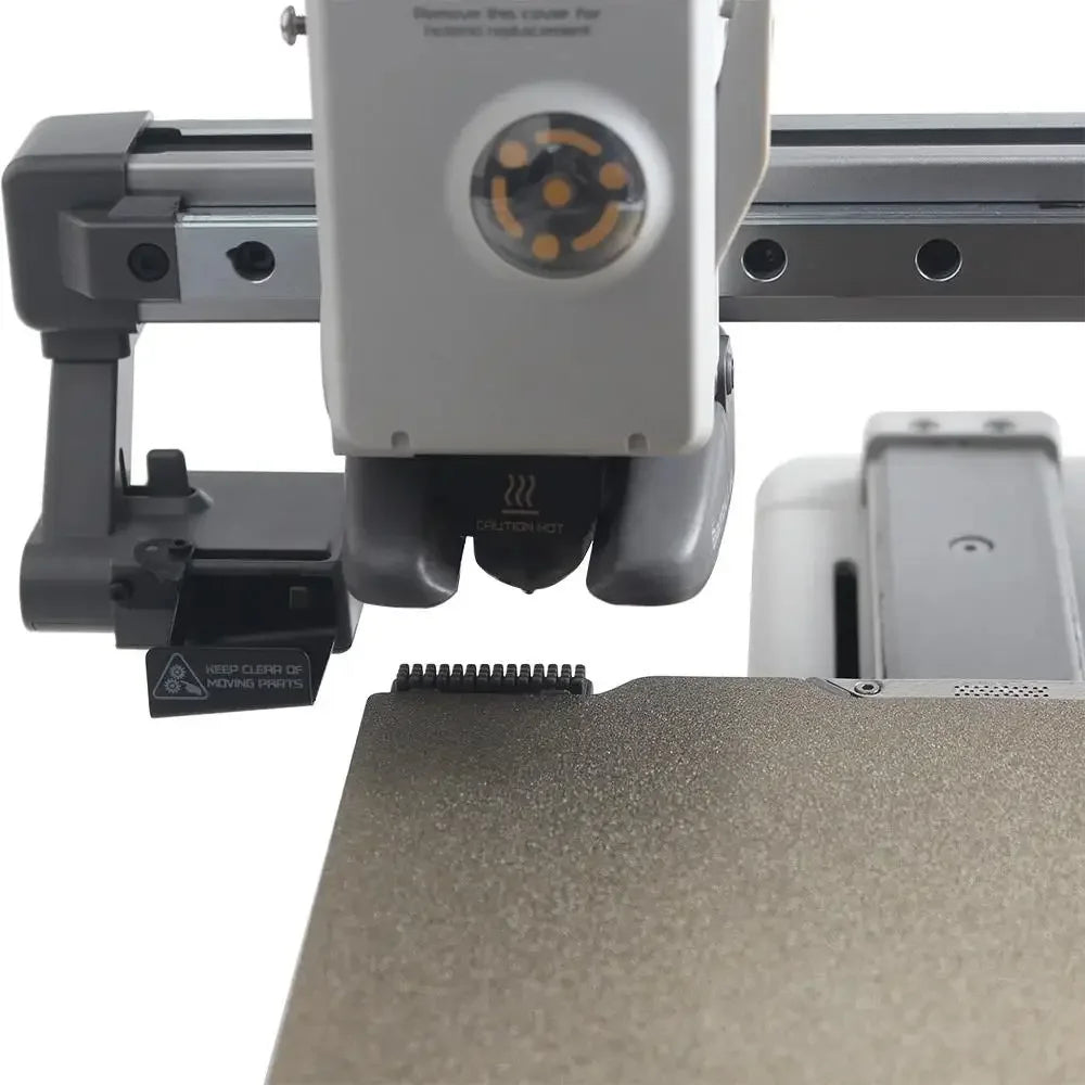 silicone nozzle cleaner brush wiping extruder nozzle on Bambu Lab A1 3D printer to clear residue