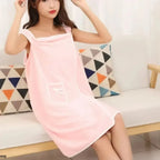 wearable bath towel worn with shoulder straps by woman in pink quick dry spa bathrobe