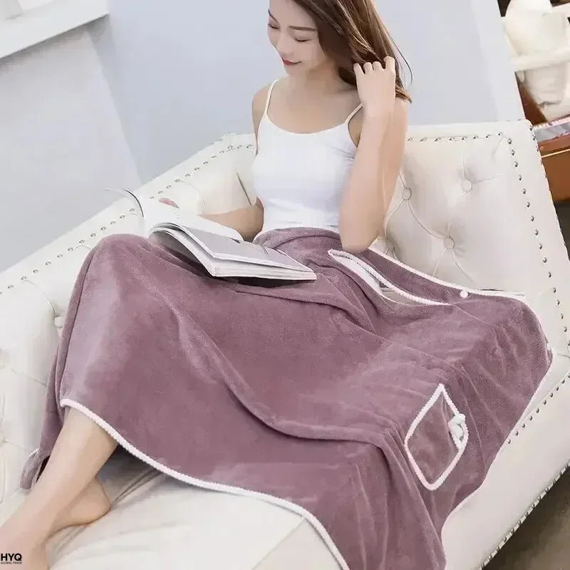 wearable bath towel worn by woman sitting on sofa in purple fast dry shower wrap dress
